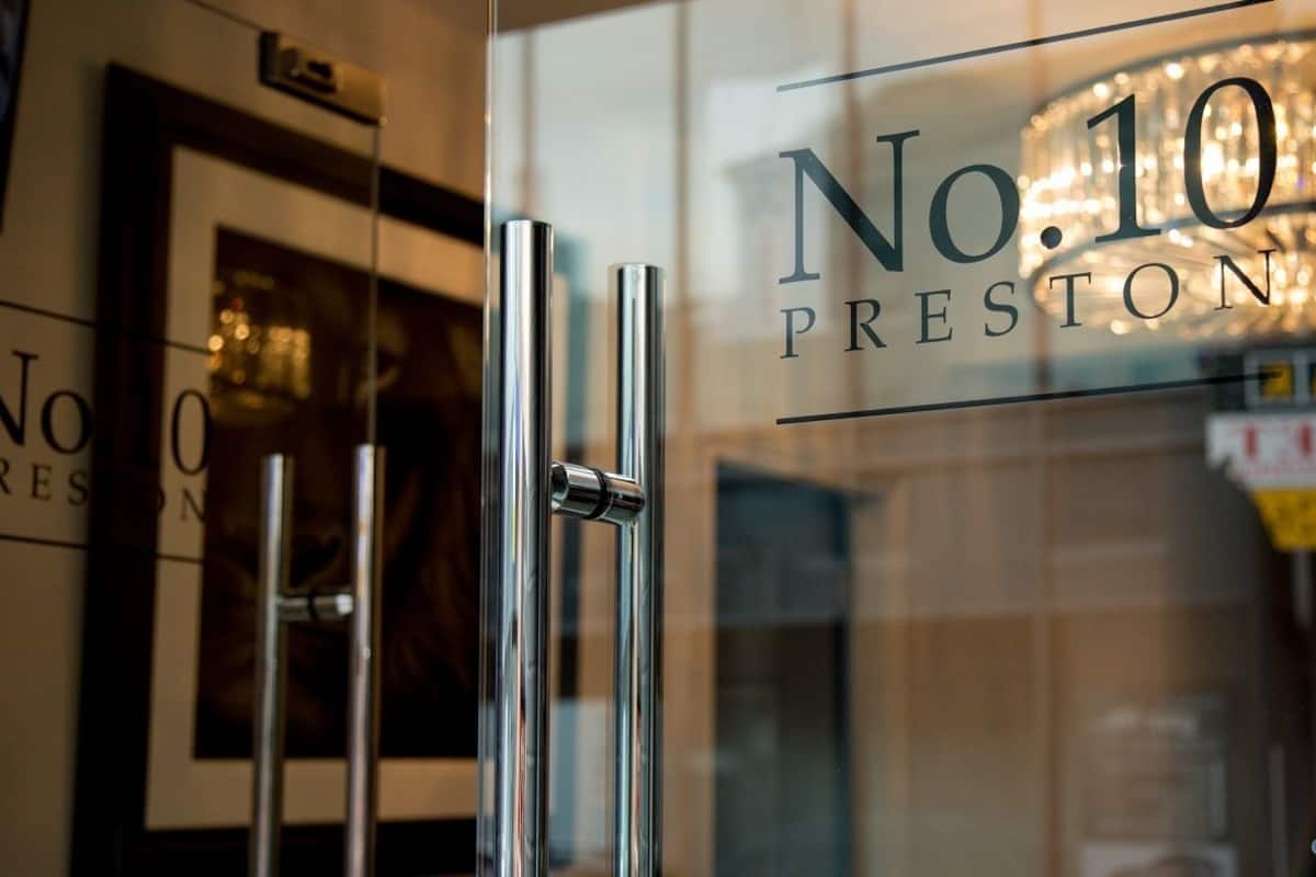 A glass door with the inscription "No.10 Preston" and a modern, metallic handle.
