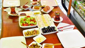 A breakfast table with various dishes and utensils. - Balım Sultany (Cesme)