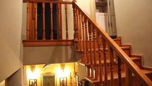 A wooden staircase with a handrail leading to a second floor. - Balım Sultany (Cesme)