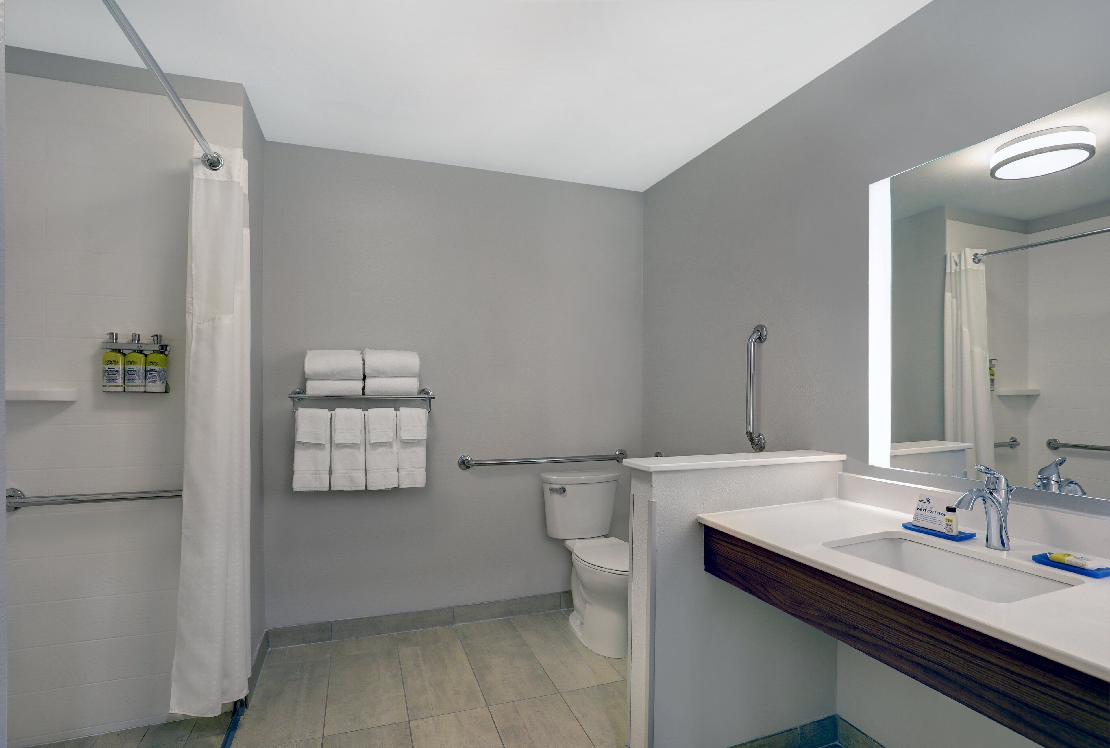A bathroom with a shower, toilet, and sink.