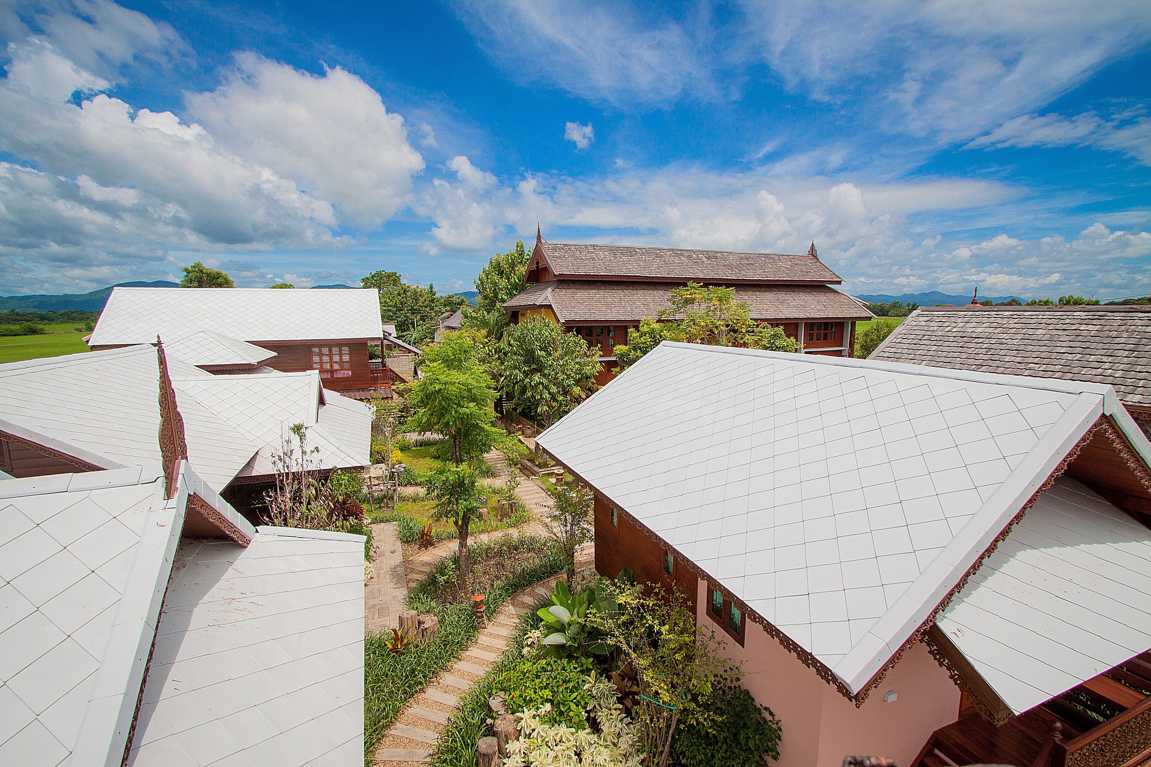 A traditional village with multiple houses featuring sloped roofs and a central pathway.