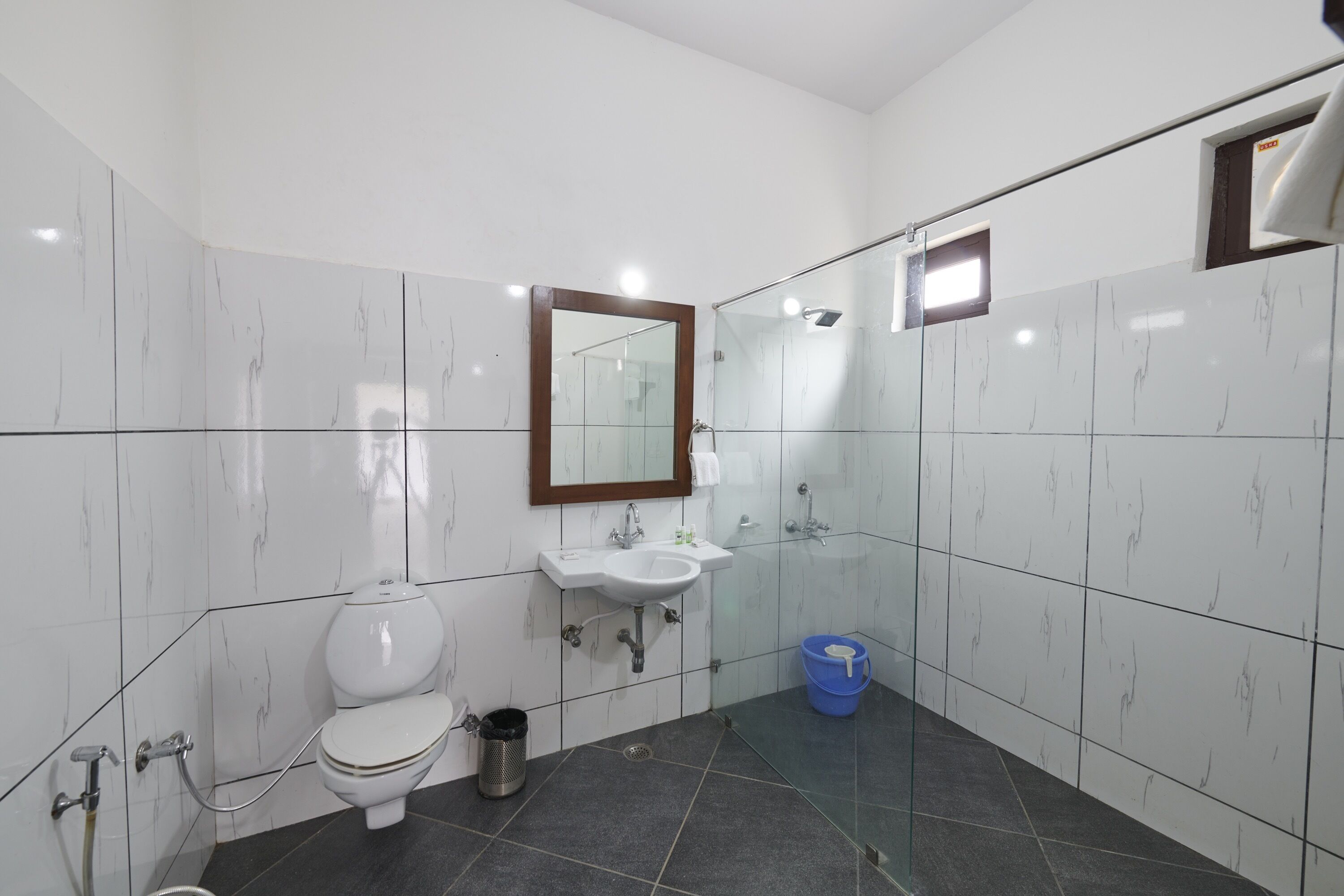 A modern bathroom with a toilet, sink, and shower.