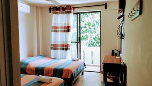 A bedroom with two beds, a ceiling fan, a window with curtains, and a wooden bench. - Yuu-lee Casa Bendita Huatulco (Santa María Huatulco)