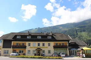 A building with a sign reading "Gasthof Winkler" with a mountain backdrop. - Gasthof-Hotel Winkler (Muhldorf)