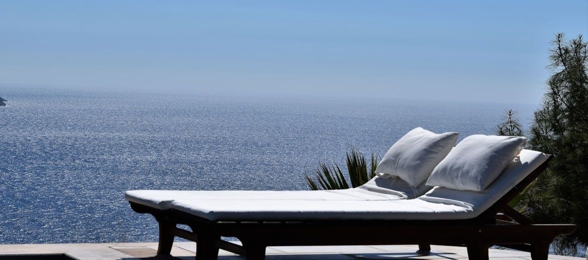 A sun lounger with a view of the sea.