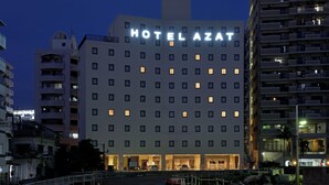 A multi-story hotel with a prominent "HOTEL AZAT" sign, featuring a modern architectural design with evenly spaced windows and a flat roof. - HOTEL AZAT Naha (Naha)