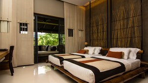 A modern hotel room with two beds, a wooden bench, a desk, and a large window with a view of greenery. - Kirimaya Golf Resort Spa (Pak Chong)