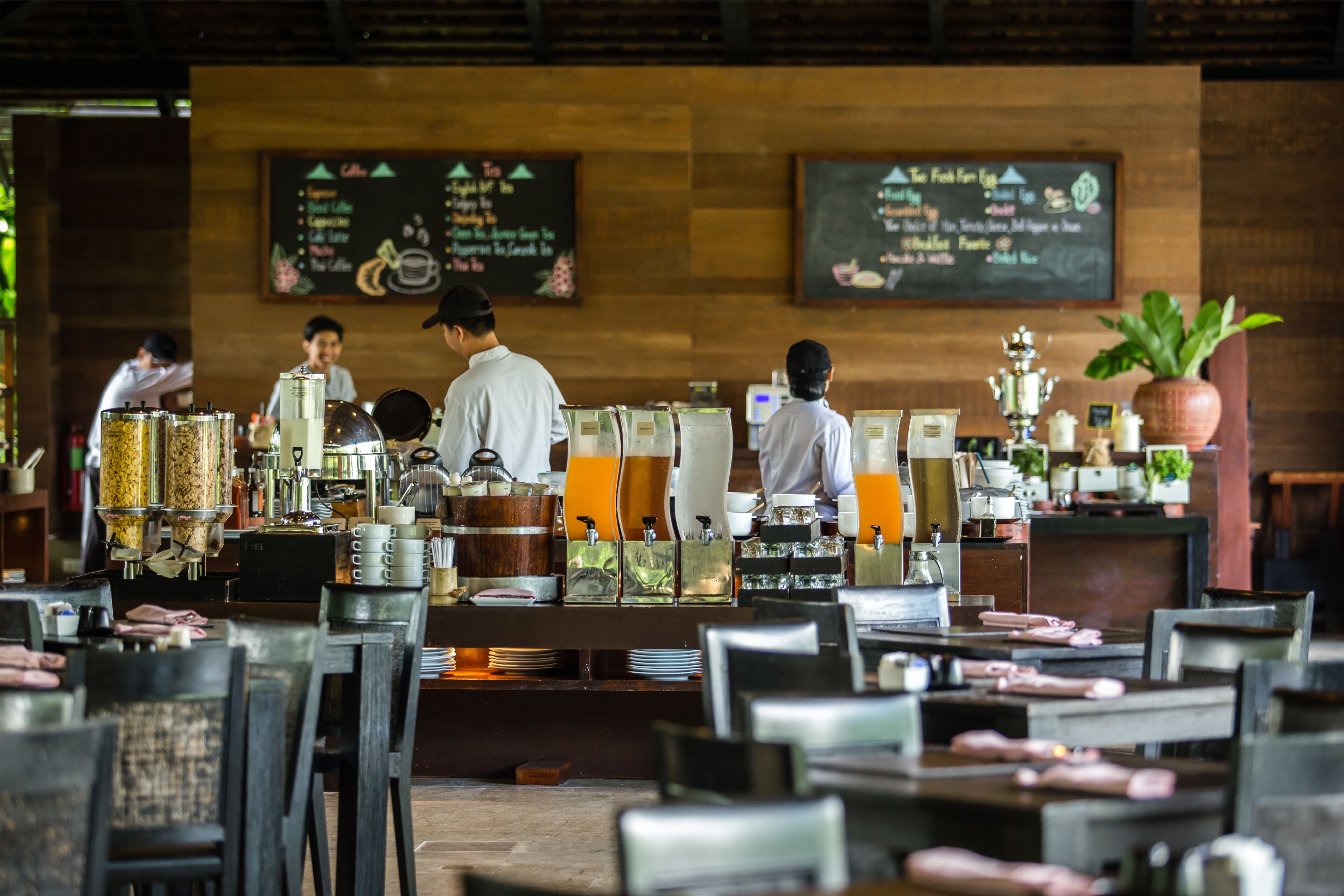 A restaurant with a wooden interior, a chalkboard menu, and baristas preparing drinks.