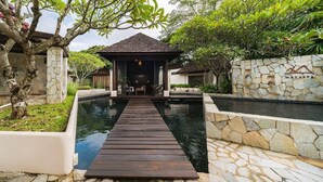 A wooden deck leading to a gazebo with a stone wall and a sign reading 'MAYASPA' in the background. - atta Lakeside Resort Suite (Pak Chong)