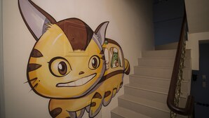 Una escalera con un mural en la pared de un personaje de caricatura.