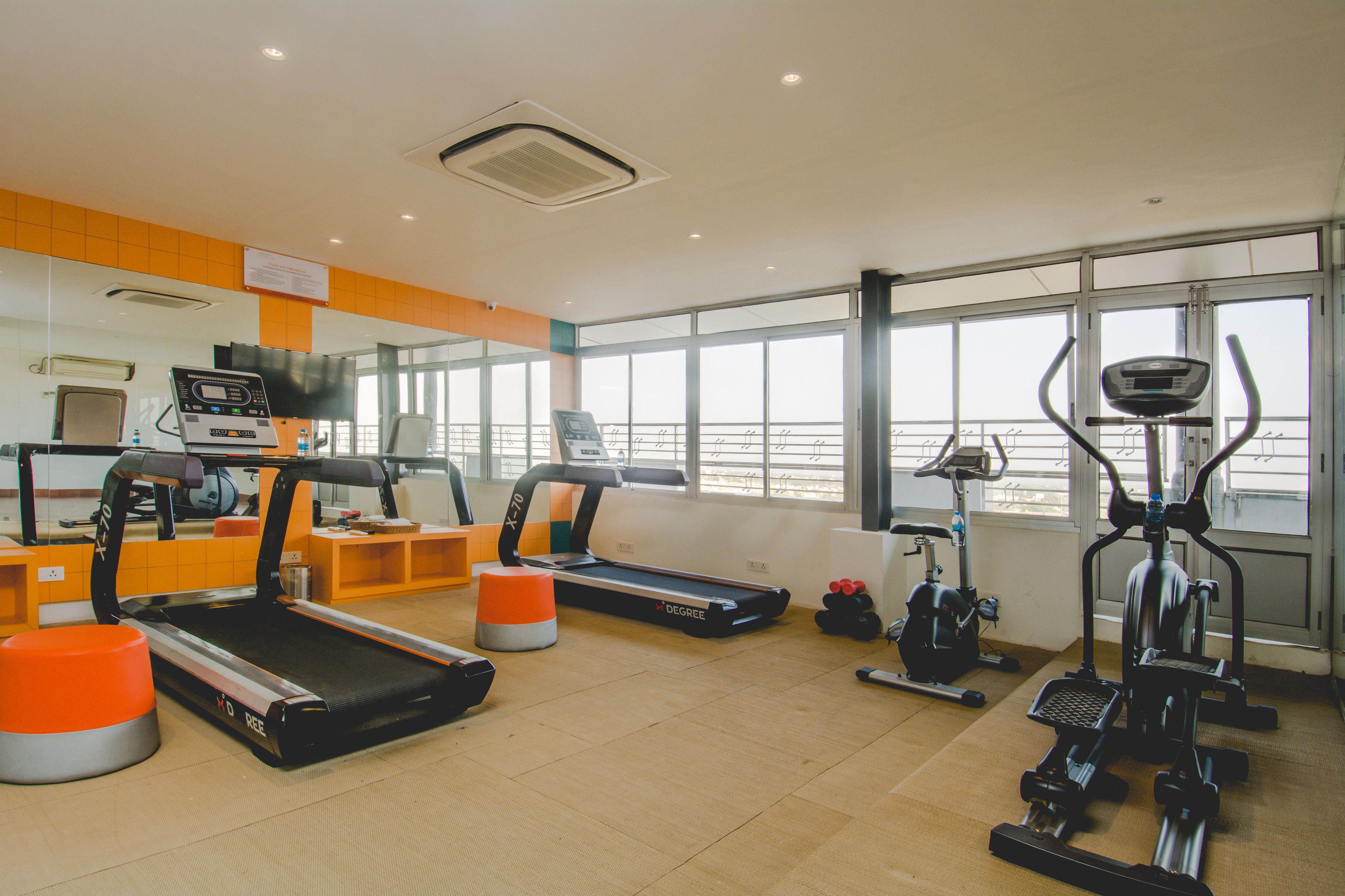 A gym with treadmills, an elliptical, and a stationary bike.