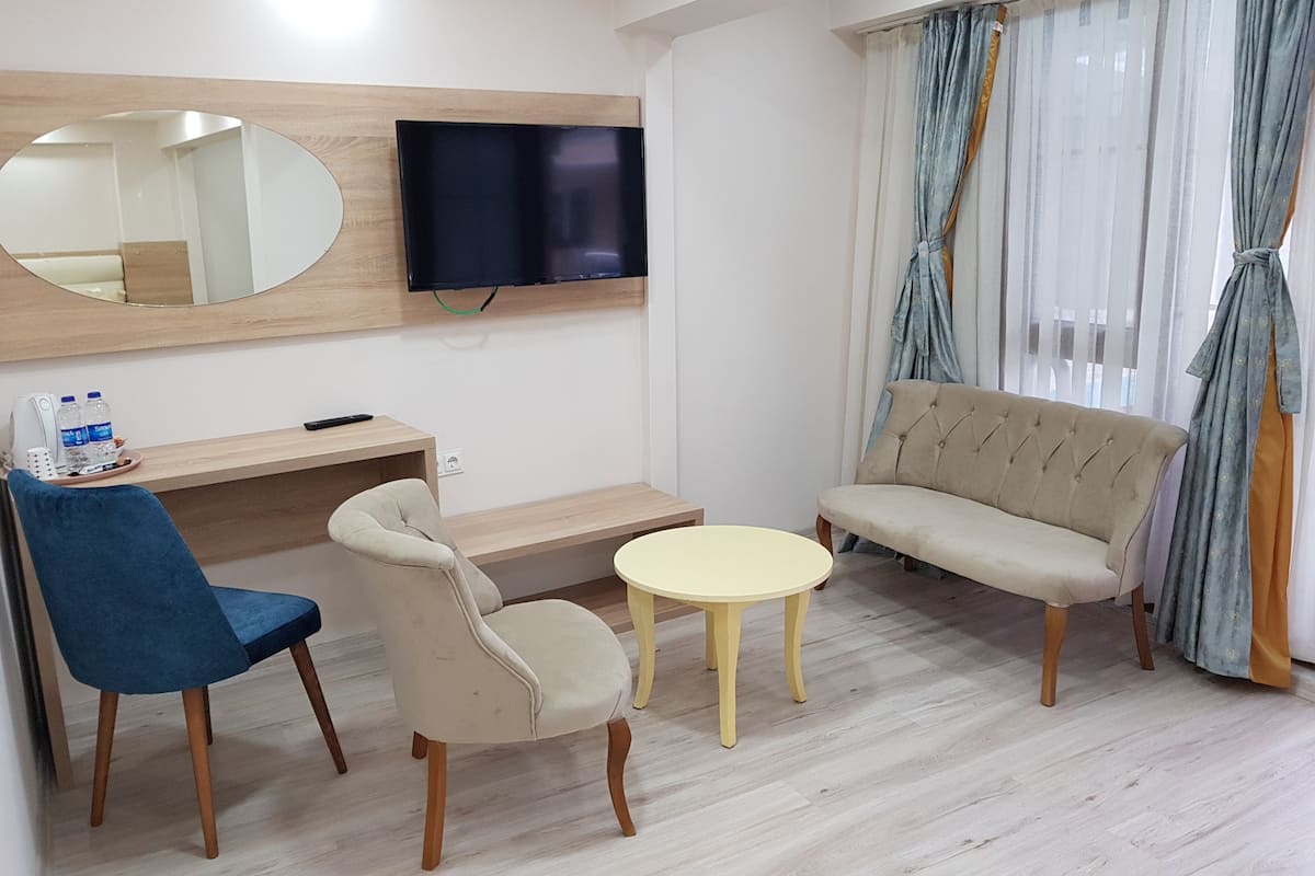 deluxe triple room, 1 bedroom, garden view | living room | lcd tv
