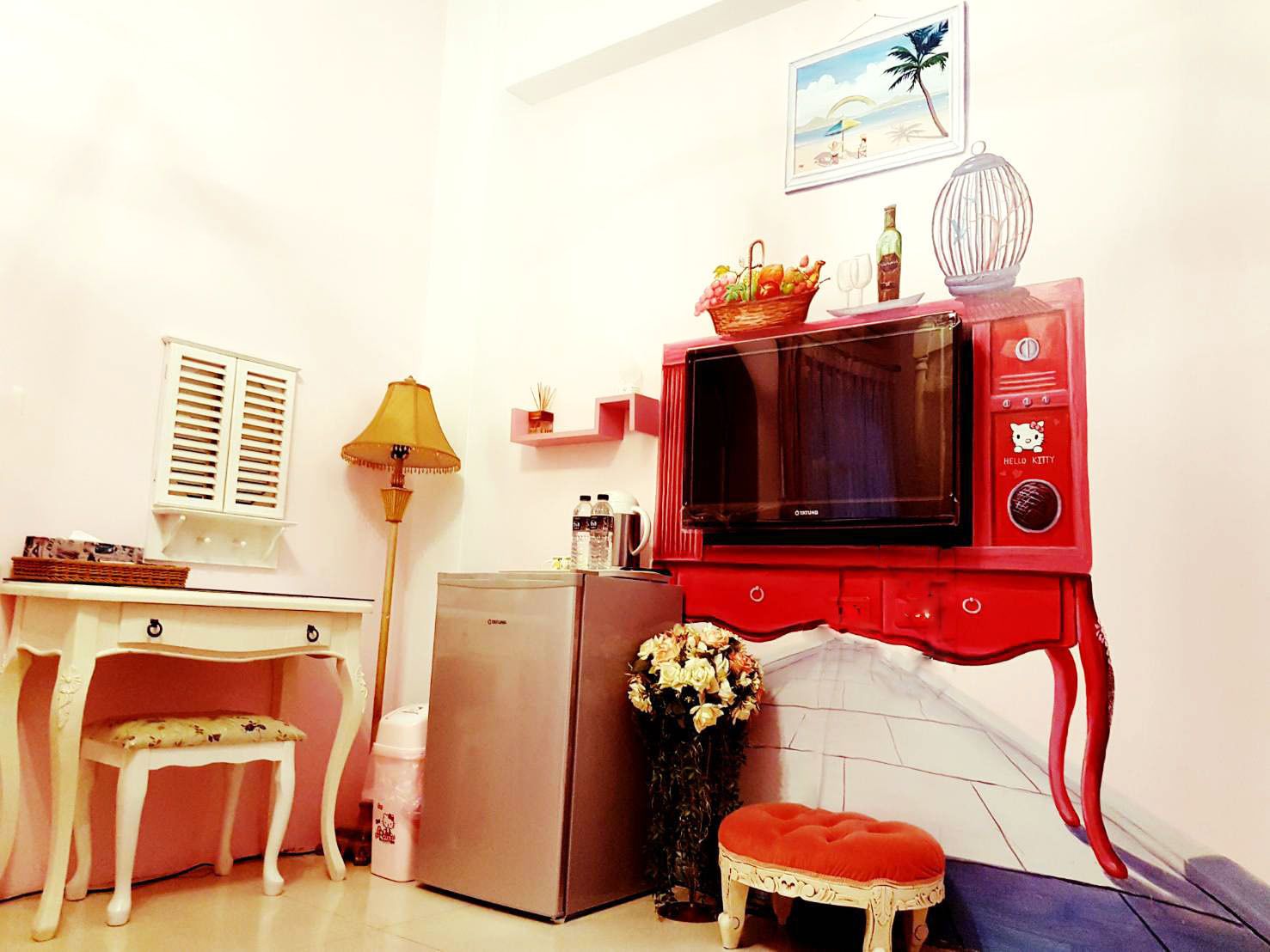 A compact kitchen with a refrigerator, microwave, and a small table with a chair.