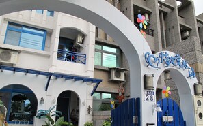 Welcome to the entrance of our hotel, featuring a distinctive arched gateway and clear signage.
