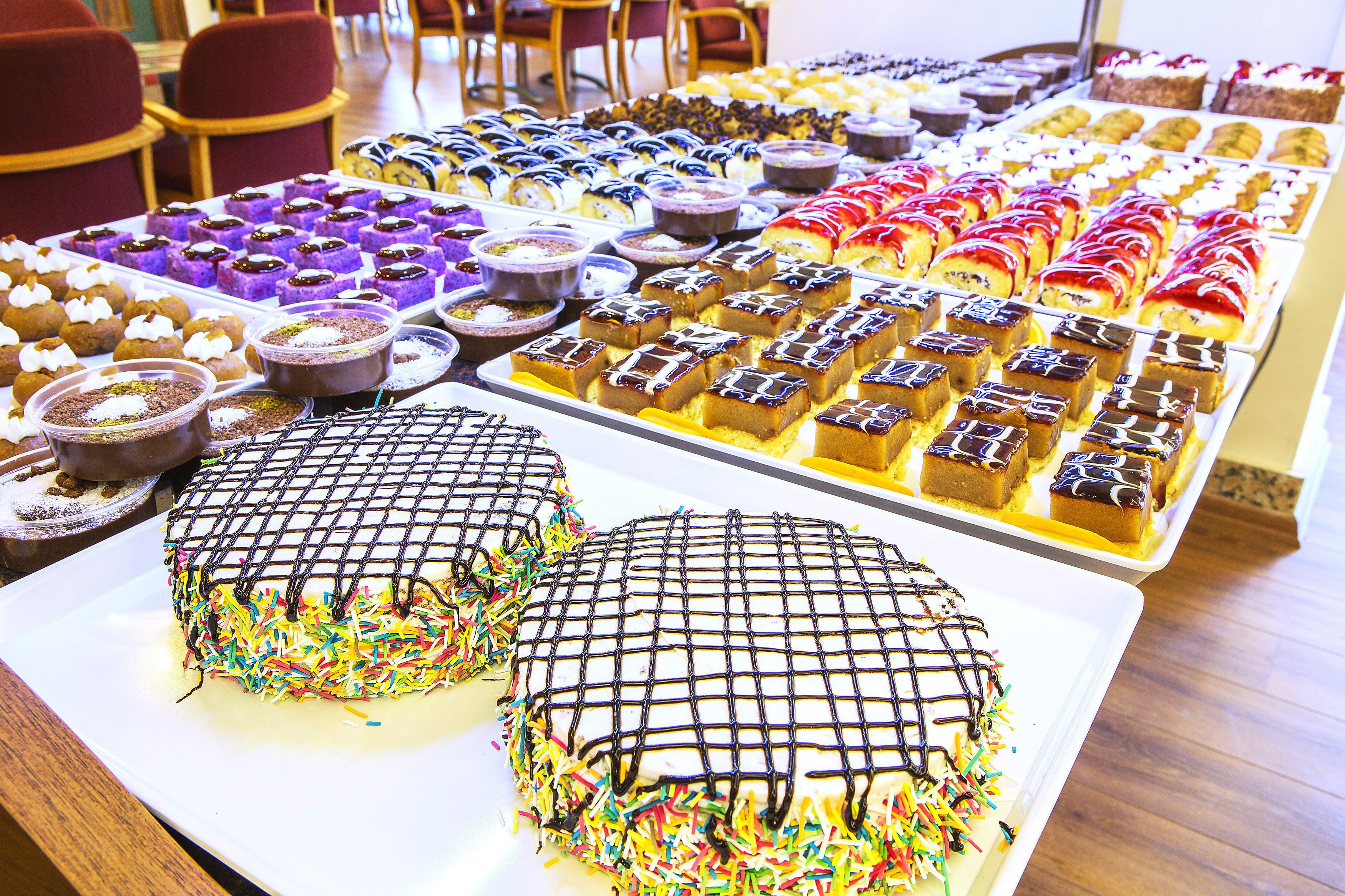 A variety of desserts displayed on trays.