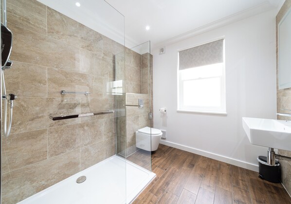 A modern bathroom with a glass shower enclosure, a white toilet, and a sink. - Westlands of Pitlochry (Pitlochry)