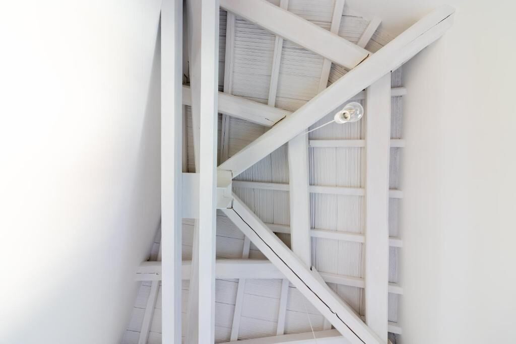 A white staircase with a simple design, leading to an upper level.