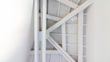 A white staircase with a simple design, leading to an upper level.