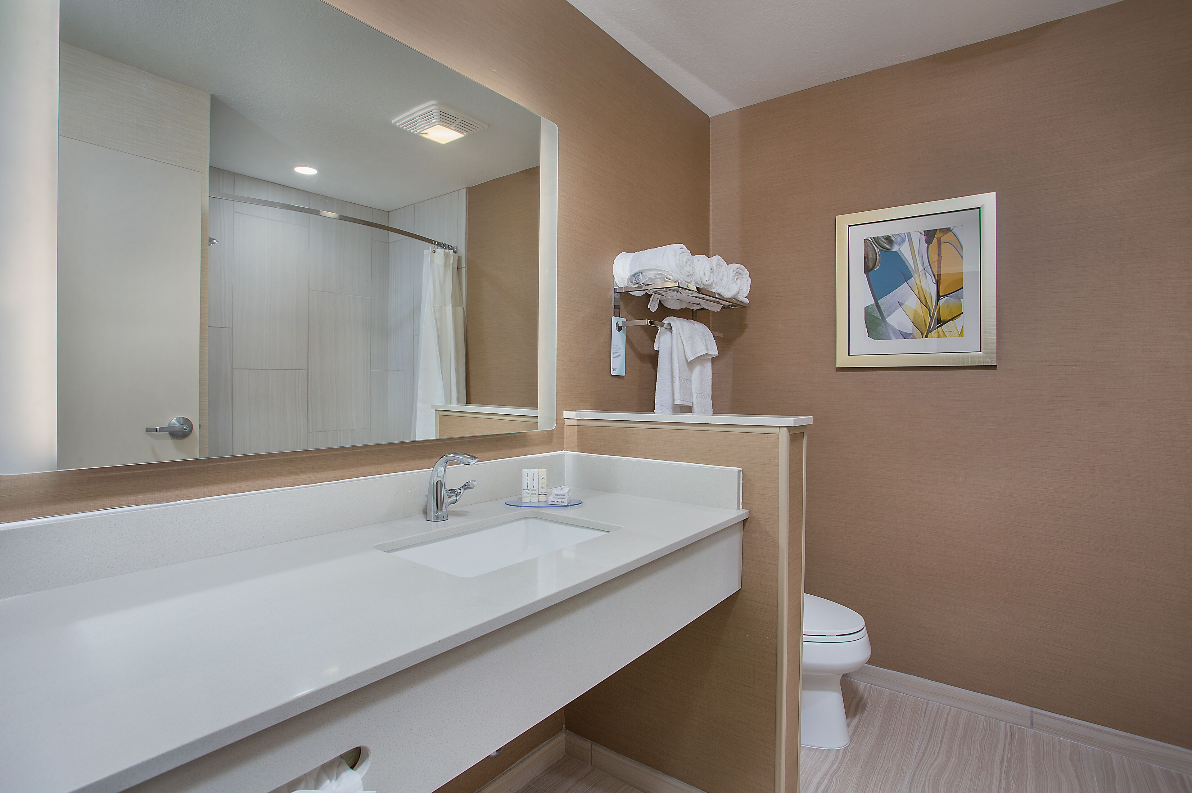 designer toiletries, hair dryer, towels