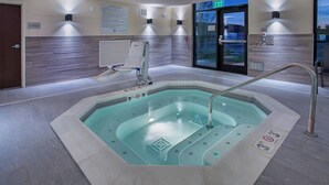 A modern indoor swimming pool with clear water, a hot tub, and a shower area. - Fairfield Inn & Suites by Marriott Nashville Hendersonville (Hendersonville)