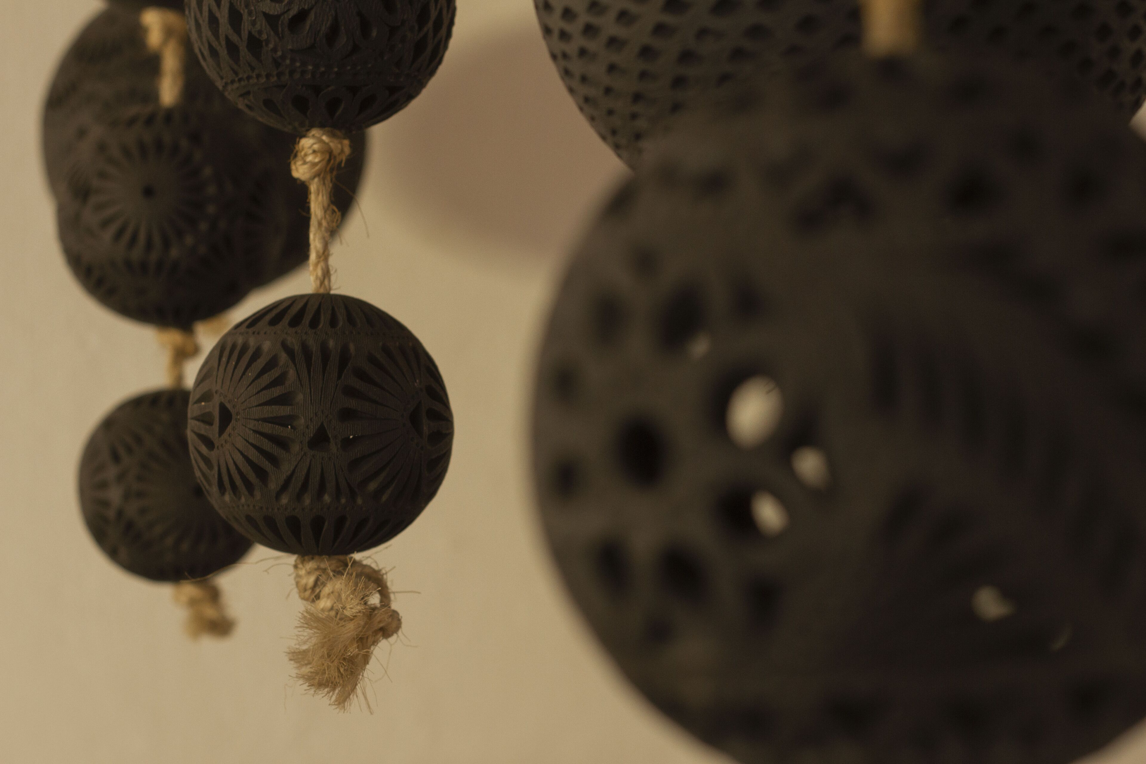 A close-up of a decorative object with a textured surface and a rope detail.