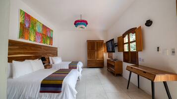 A hotel room with two beds, a wooden headboard, a colorful artwork, a TV, and a desk.
