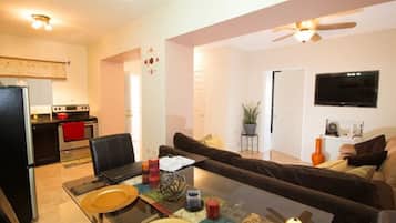 Quadruple Room, 1 Bedroom | Living area | Flat-screen TV