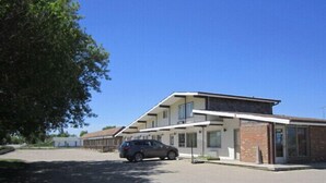 A modern two-story building with a flat roof and large windows. - Virden Motel (Virden)