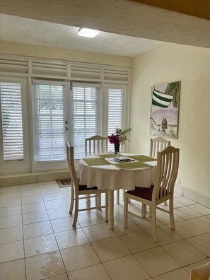 Enjoy meals in this elegant dining area with a round table for four, surrounded by comfortable chairs.