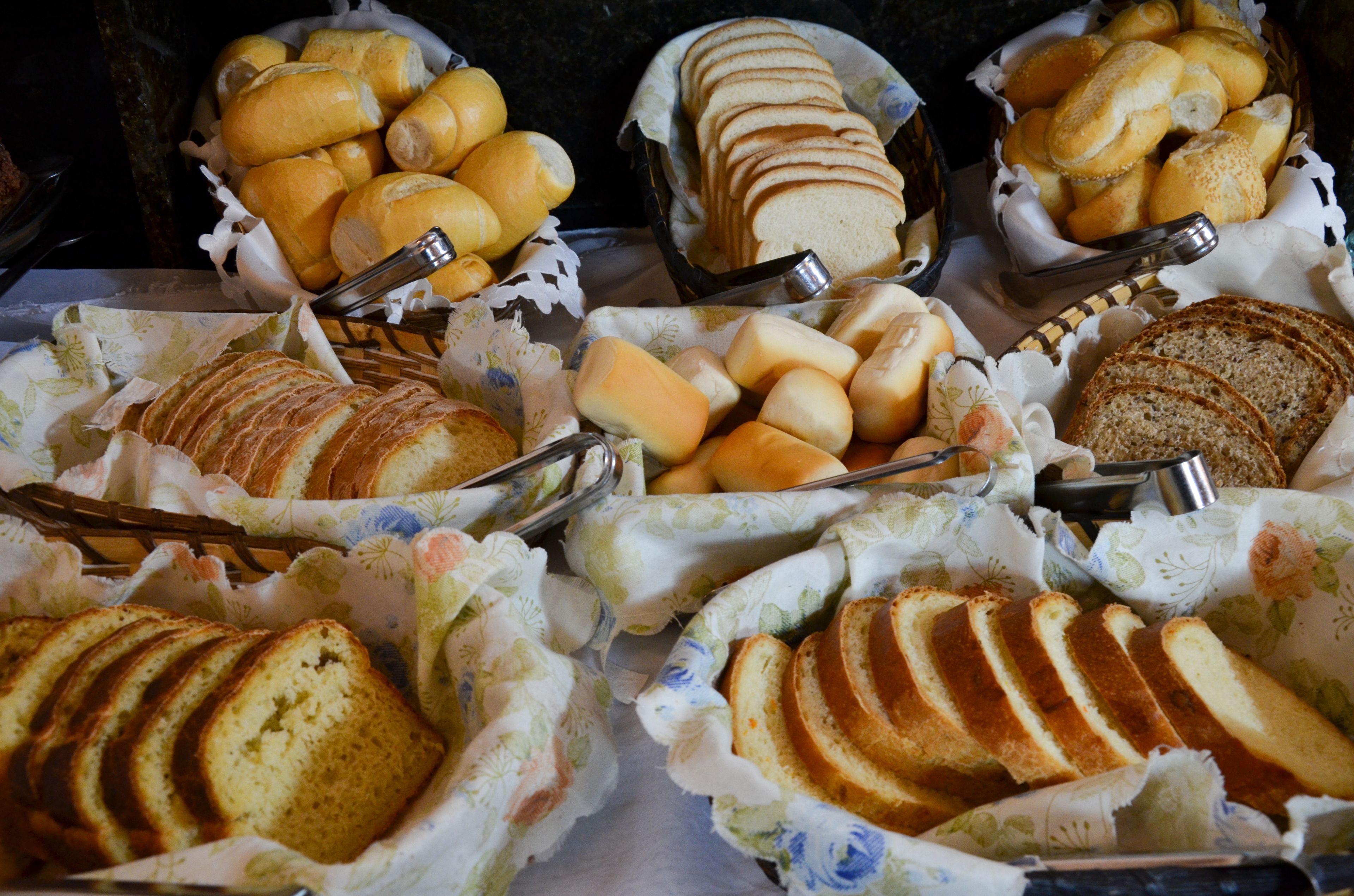 A variety of breads and pastries displayed in baskets.