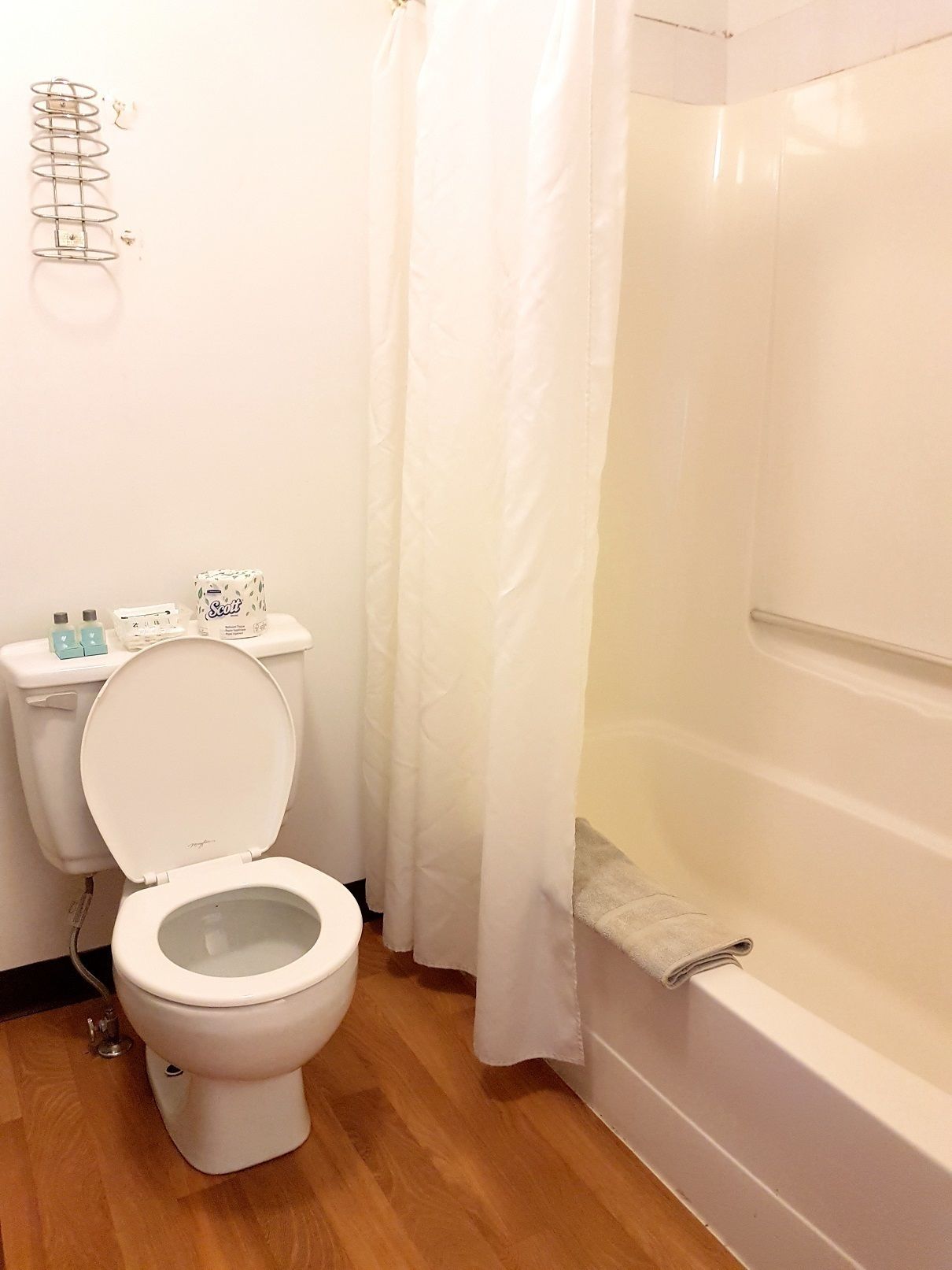 A bathroom with a toilet, a shower, and a bathtub.