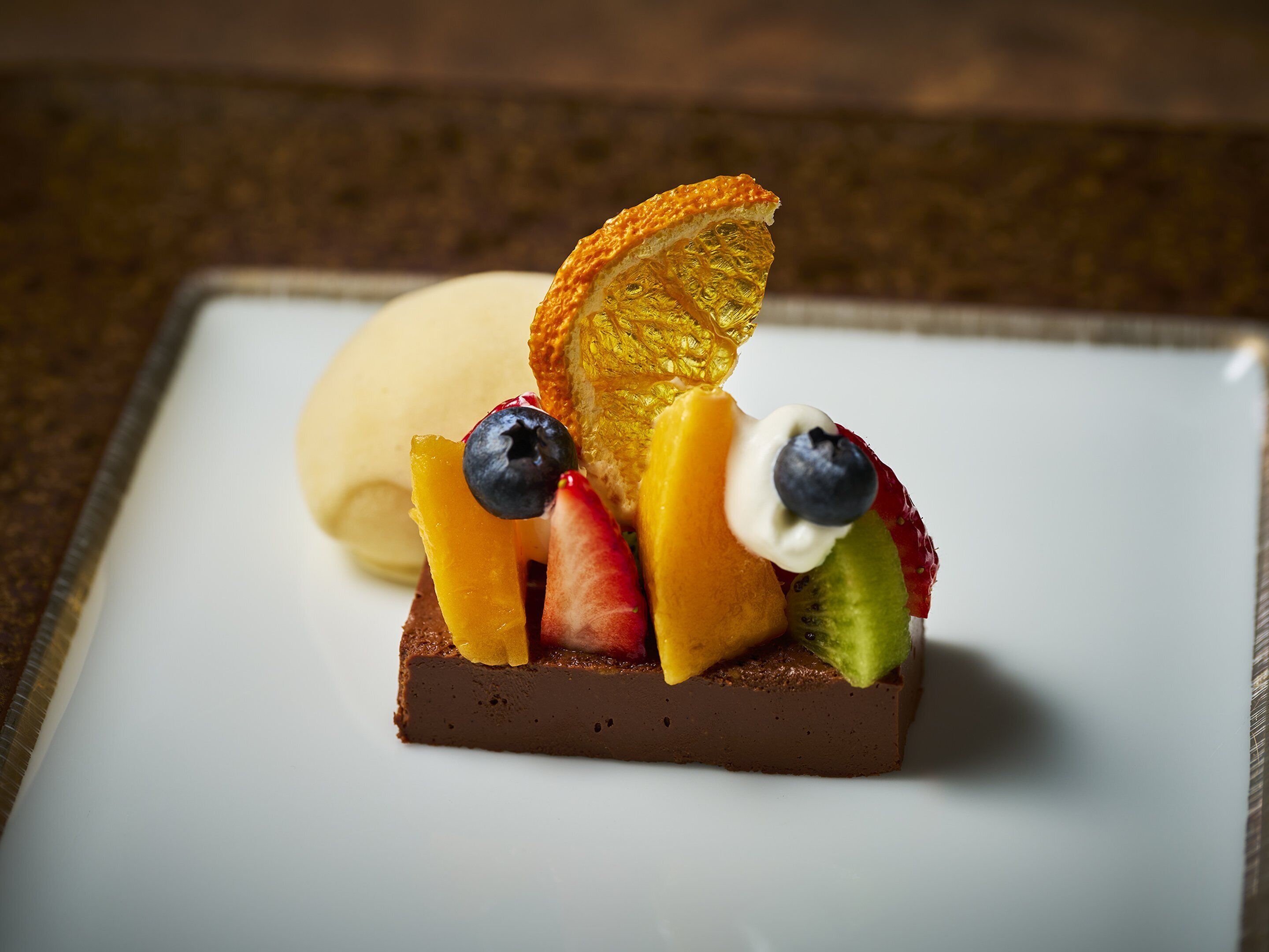 A dessert with fruit on a white plate.