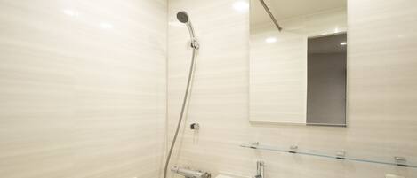 A modern bathroom with a bathtub, a sink, and a shower.