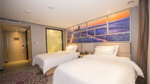 A hotel room with two beds, a large window with a sunset view, a shower area, and a door to the hallway. - LAVADE HOTEL GZ KECUN METRO STATION BRANCH (Guangzhou)
