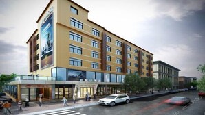 A multi-story hotel with a modern design, featuring a prominent entrance with glass doors and a large sign above the entrance. - Lavande Hotel (Guangzhou)