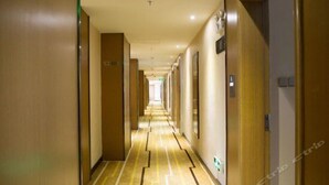 A hotel hallway with a long corridor, doors on both sides, and a patterned floor. - Lavande Hotel (Guangzhou)