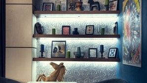 A modern living room with a wooden horse sculpture, a dining table with placemats, and a blue wall with a textured pattern. - AyKun Hotel (Astana)