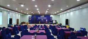A conference room with tables and chairs, a stage, and a banner for the Nepal Life Star Awards 2082.