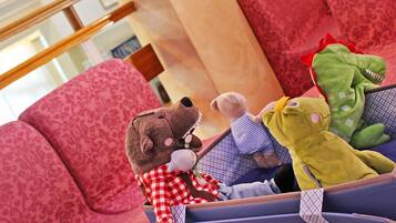 Cozy retreat with plush furniture and a friendly bear companion.
