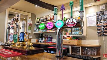 A bar with multiple taps, each labeled with different beer names.