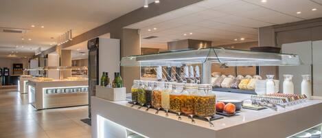 A buffet area with various food items and condiments.