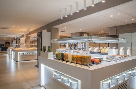 A buffet area with various food items and condiments.