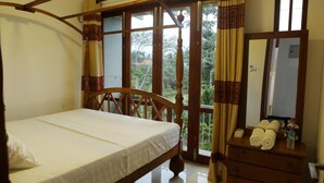 A bedroom with a wooden bed, a dresser, and a mirror. - Capital Villa (Battaramulla)