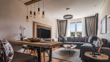 Acropolis Grand Residence | Living room | 50-inch Smart TV with cable channels, TV, Netflix
