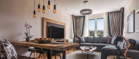 Acropolis Grand Residence | Living room | 50-inch Smart TV with cable channels, TV, Netflix