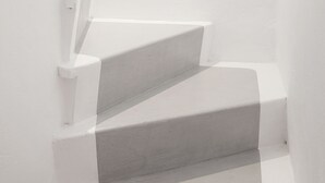 A set of white stairs leading up to a landing.