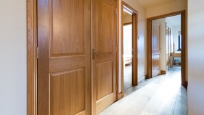 A hallway with wooden doors and a light-colored floor. - Scottish Highland Lodge (Pitlochry)