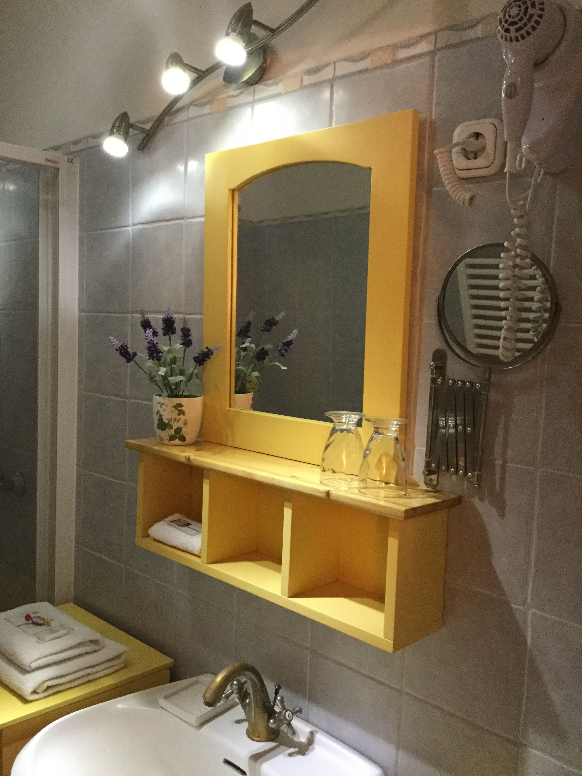 A bathroom with a sink, mirror, and towel rack.