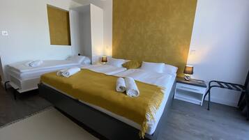 A hotel room with two beds, a large mirror, and a modern design.