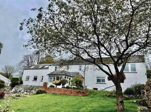 A two-story house with a large tree in the front yard. - Airds Farm Guest House (Castle Douglas)